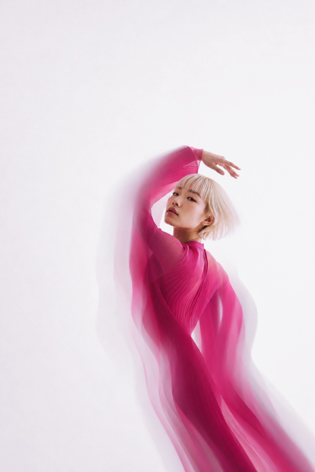 A dancer in flowing magenta, caught mid-motion