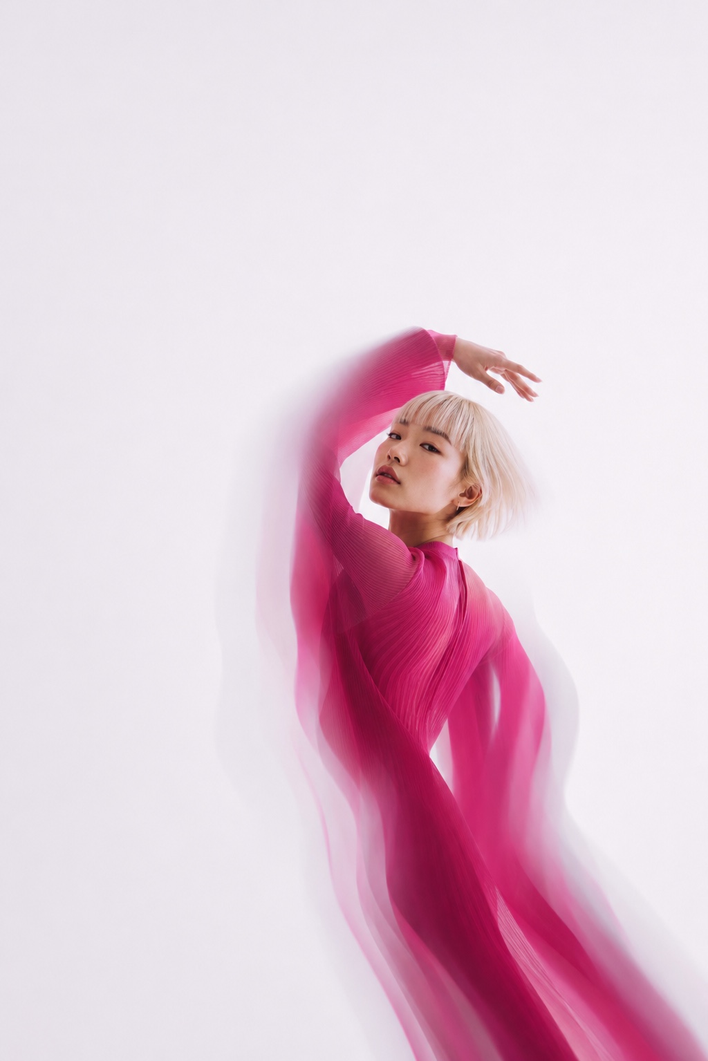 A dancer in flowing magenta, caught mid-motion